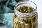 Pickled asparagus in a mason jar.