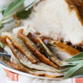 Sliced roasted turkey breast on a platter.