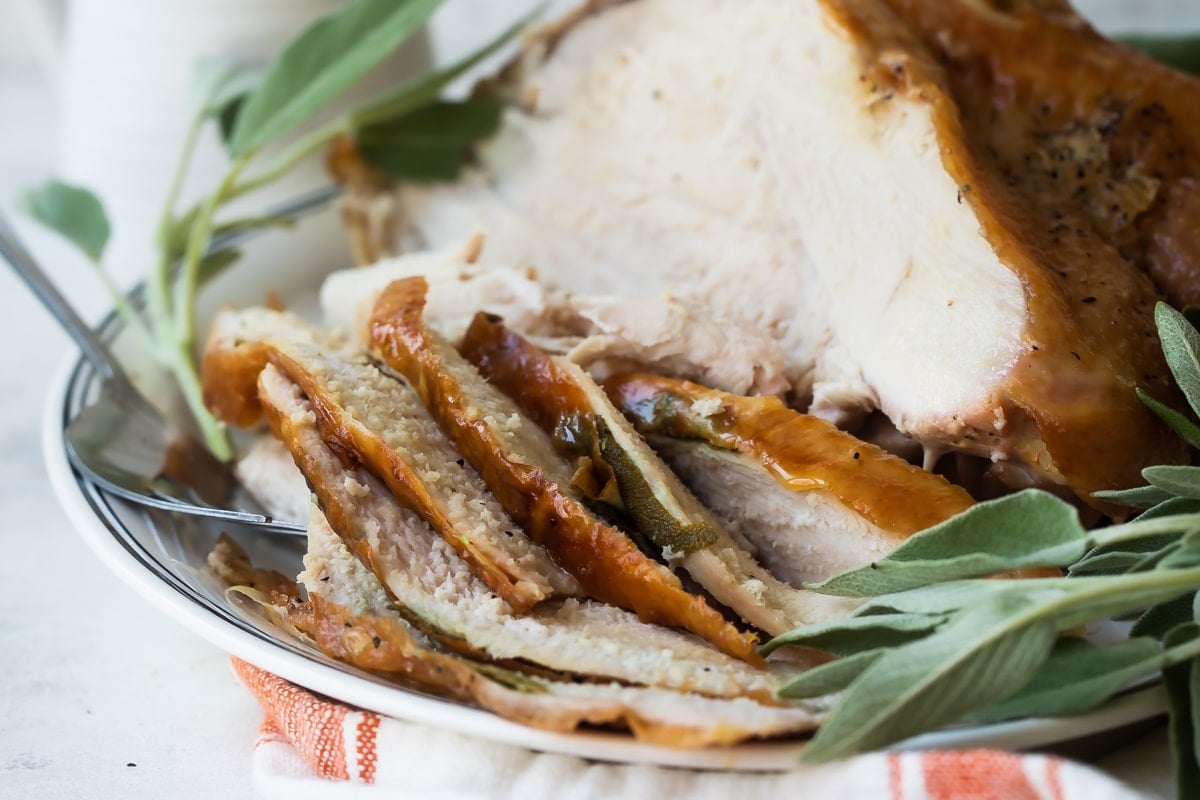 Sliced roasted turkey breast on a platter.