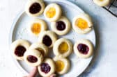 Thumbprint cookies on a gray plate.
