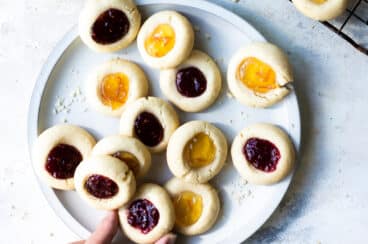 Thumbprint cookies on a gray plate.
