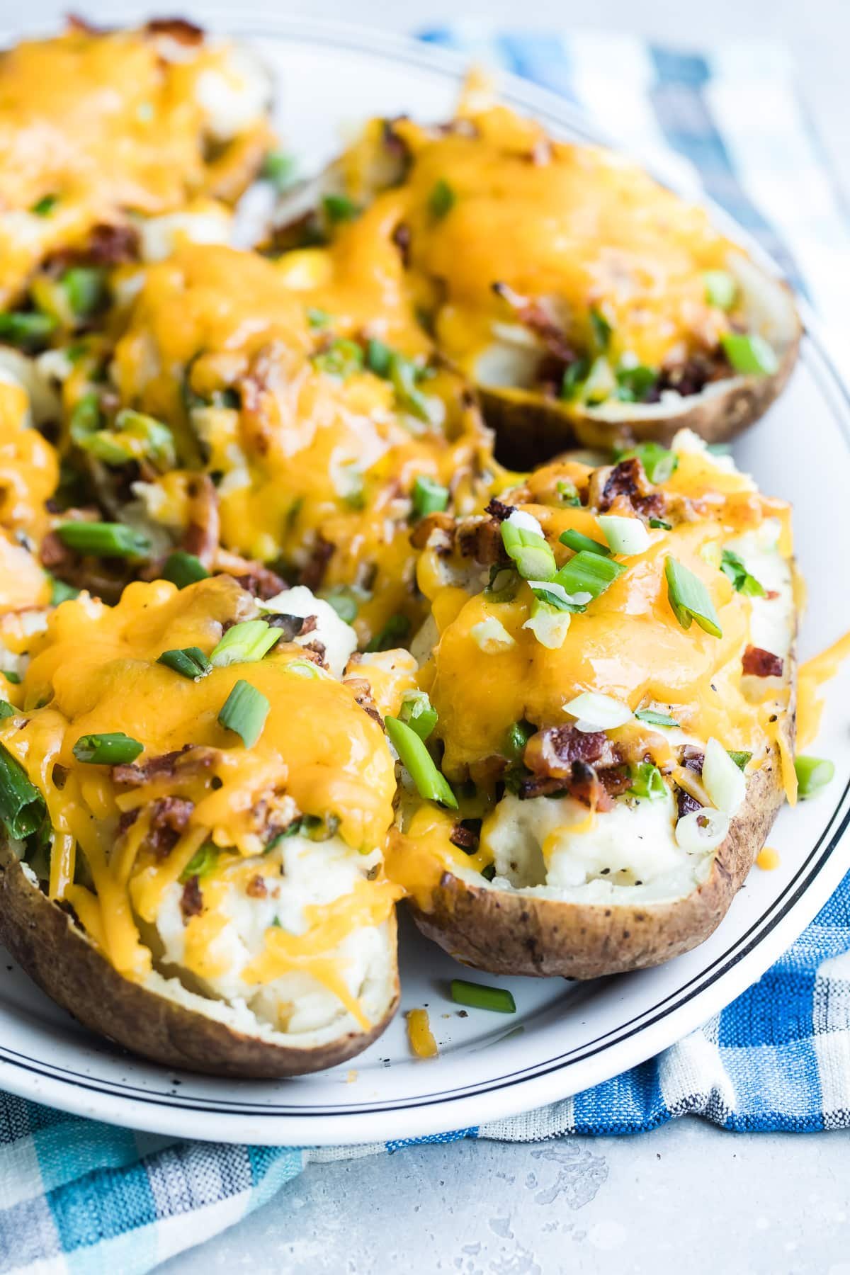 Twice baked potatoes on a white platter.