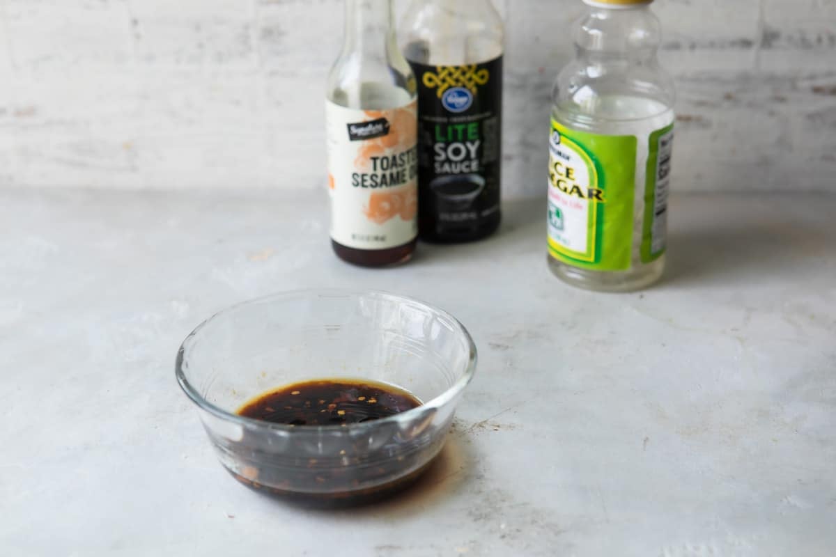 A bowl of dressing for Asian cucumber salad.
