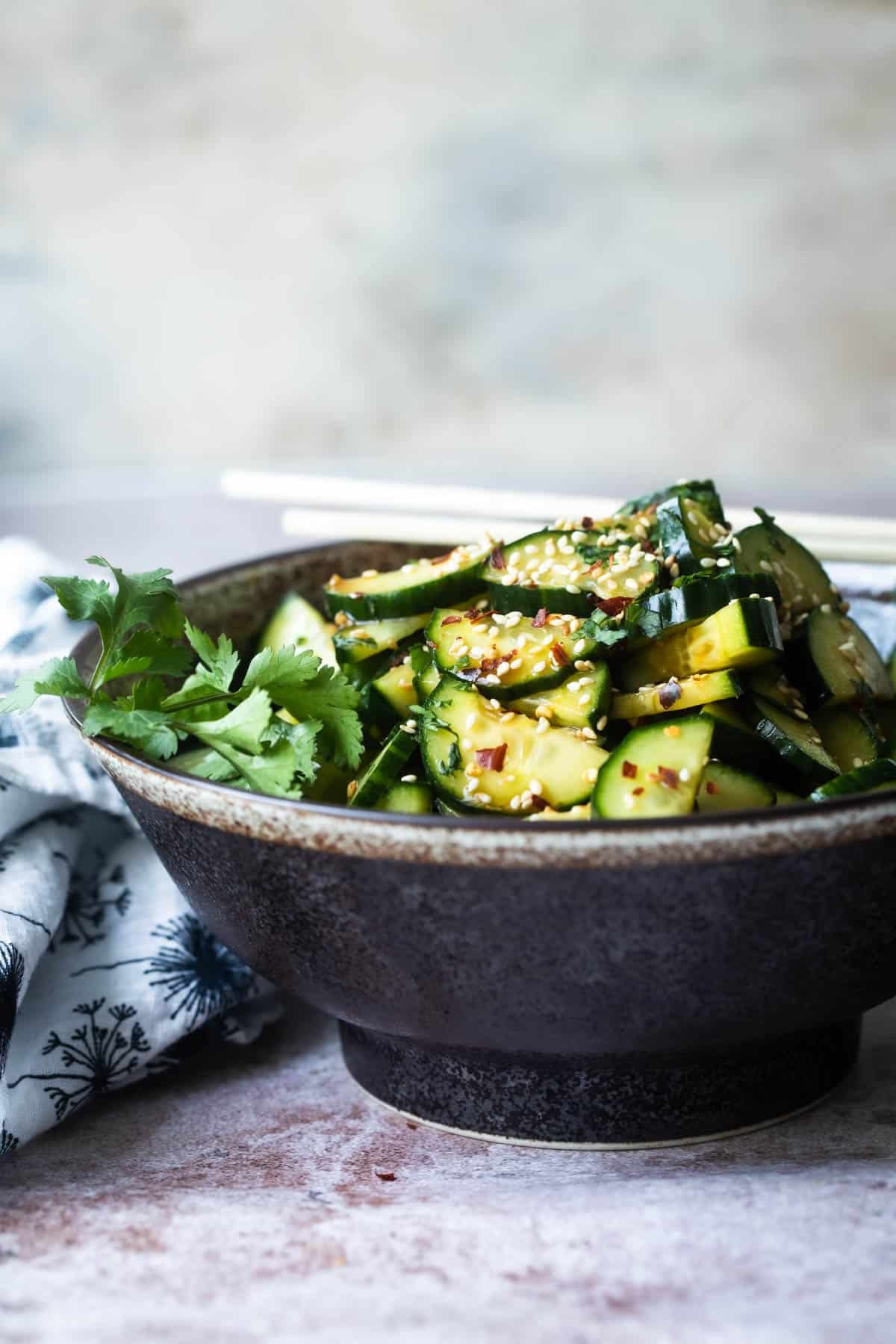 A black bowl of Asian cucumber salad.