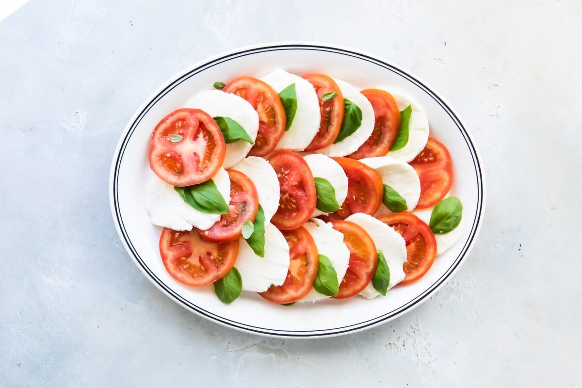 Caprese salad on a white plate.