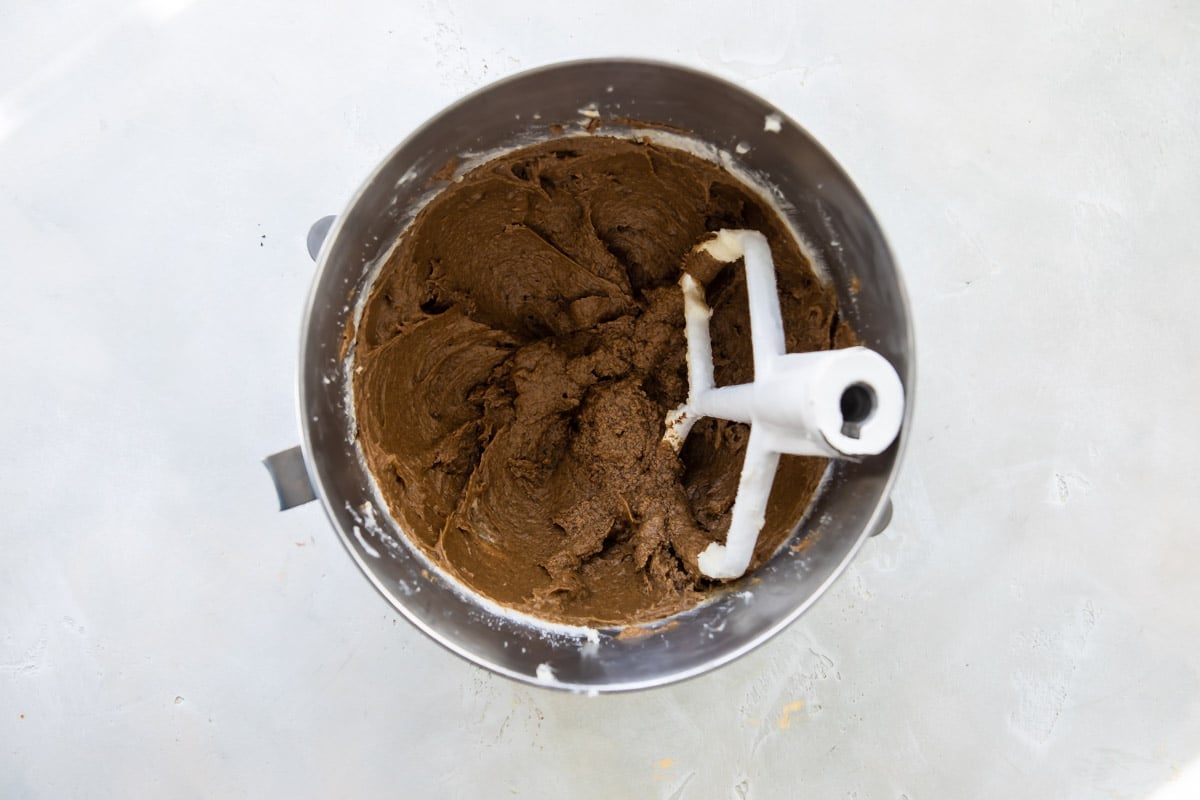 Double ginger cookie dough in a silver mixing bowl.