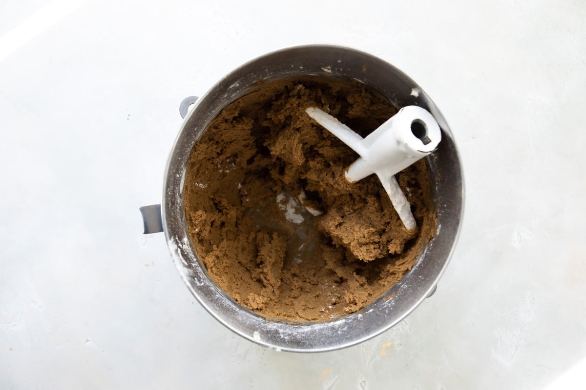 Double ginger cookie dough in a silver mixing bowl.