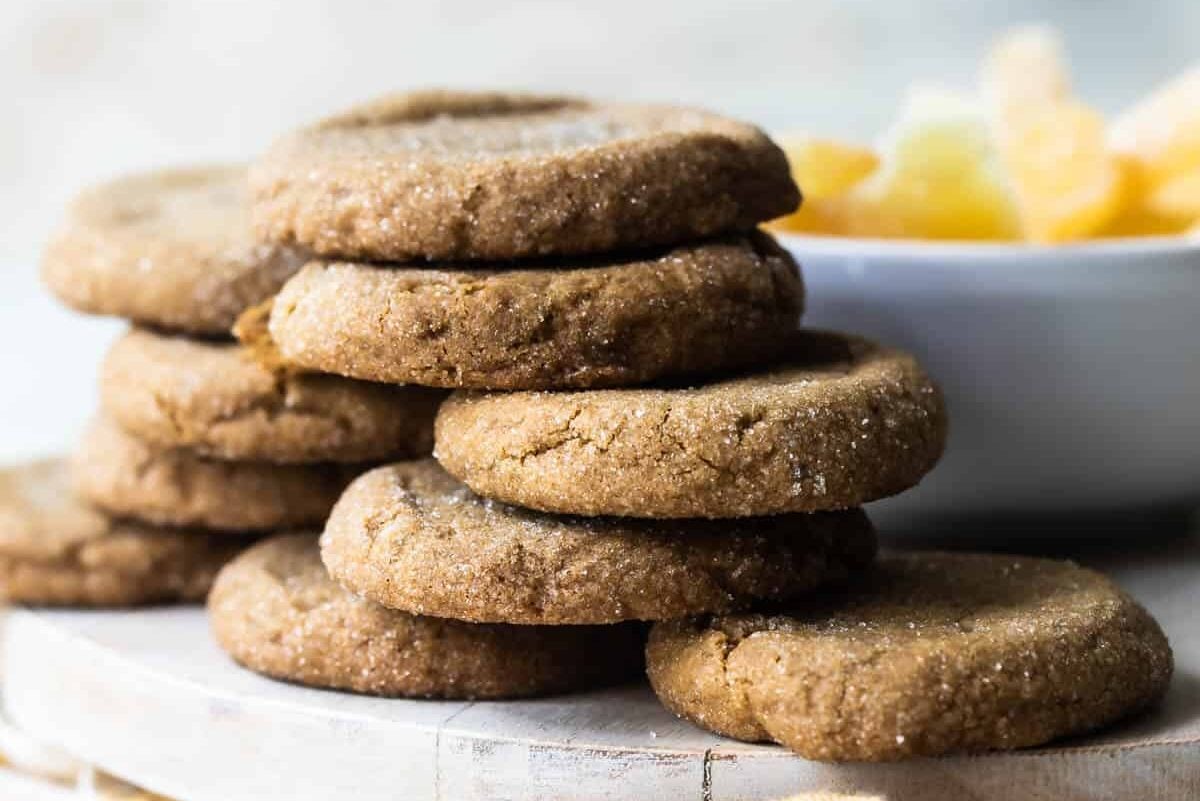 Double ginger cookies on a wooden platter.