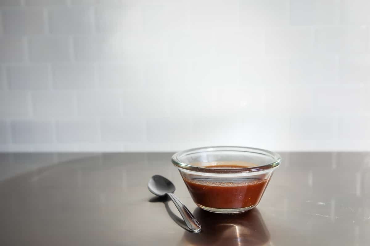 Sauce for Korean barbecue meatballs in a small glass bowl.