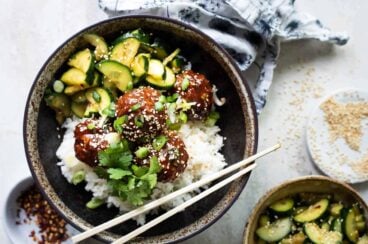 Korean barbecue meatballs, rice and cucumber in a gray bowl