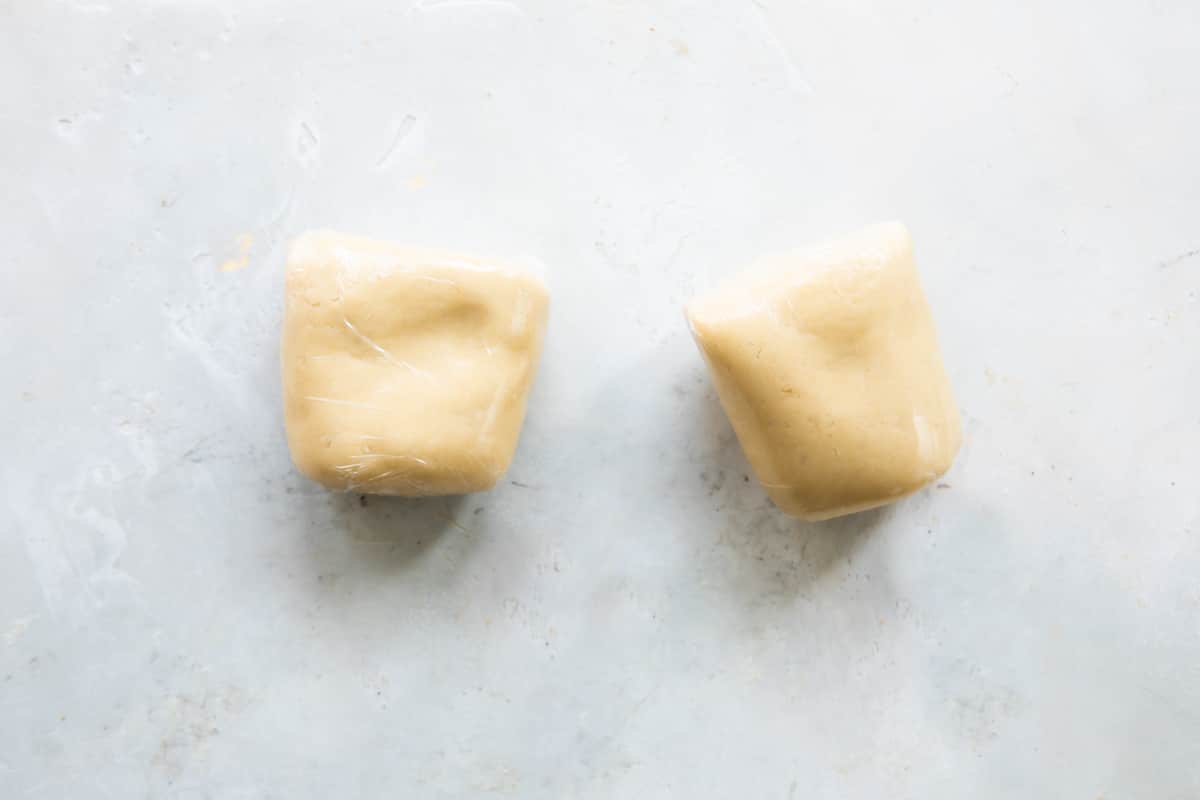 Linzer cookie dough wrapped in plastic wrap.