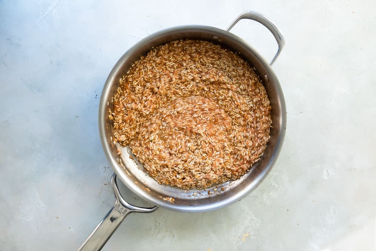 Cooking Mexican rice in a skillet.