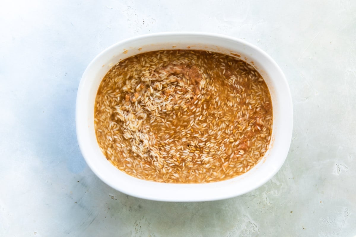 Mexican rice transferred to a baking dish to cook.