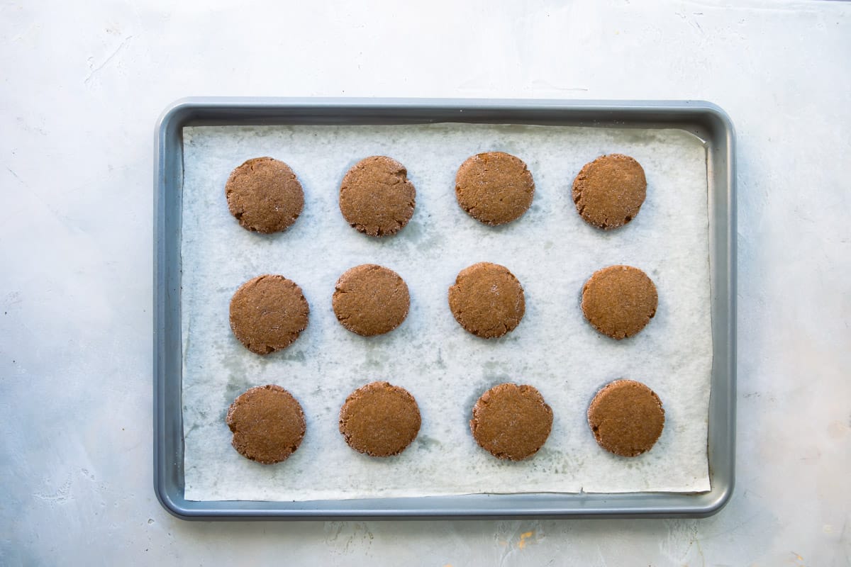 Molasses cookies on a baking sheet.