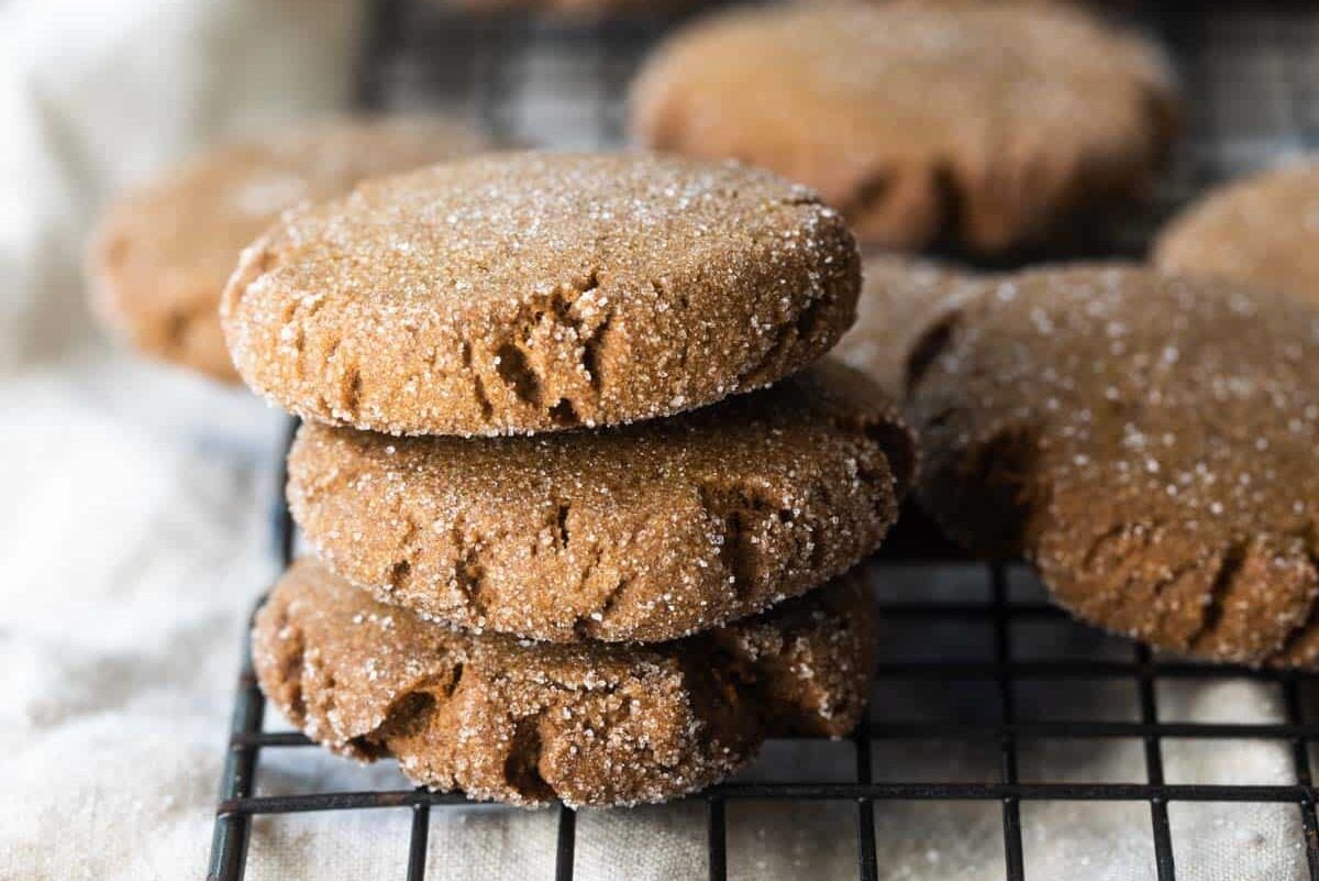Molasses cookies on a cooling rack.