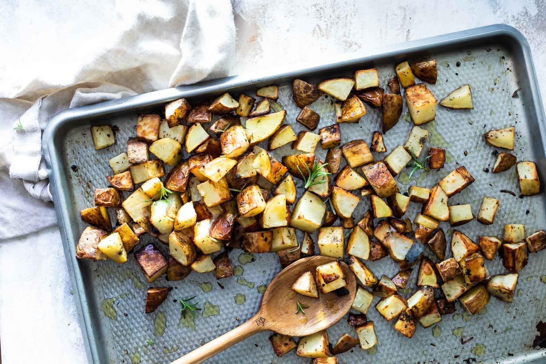A baking sheet with oven roasted potatoes.