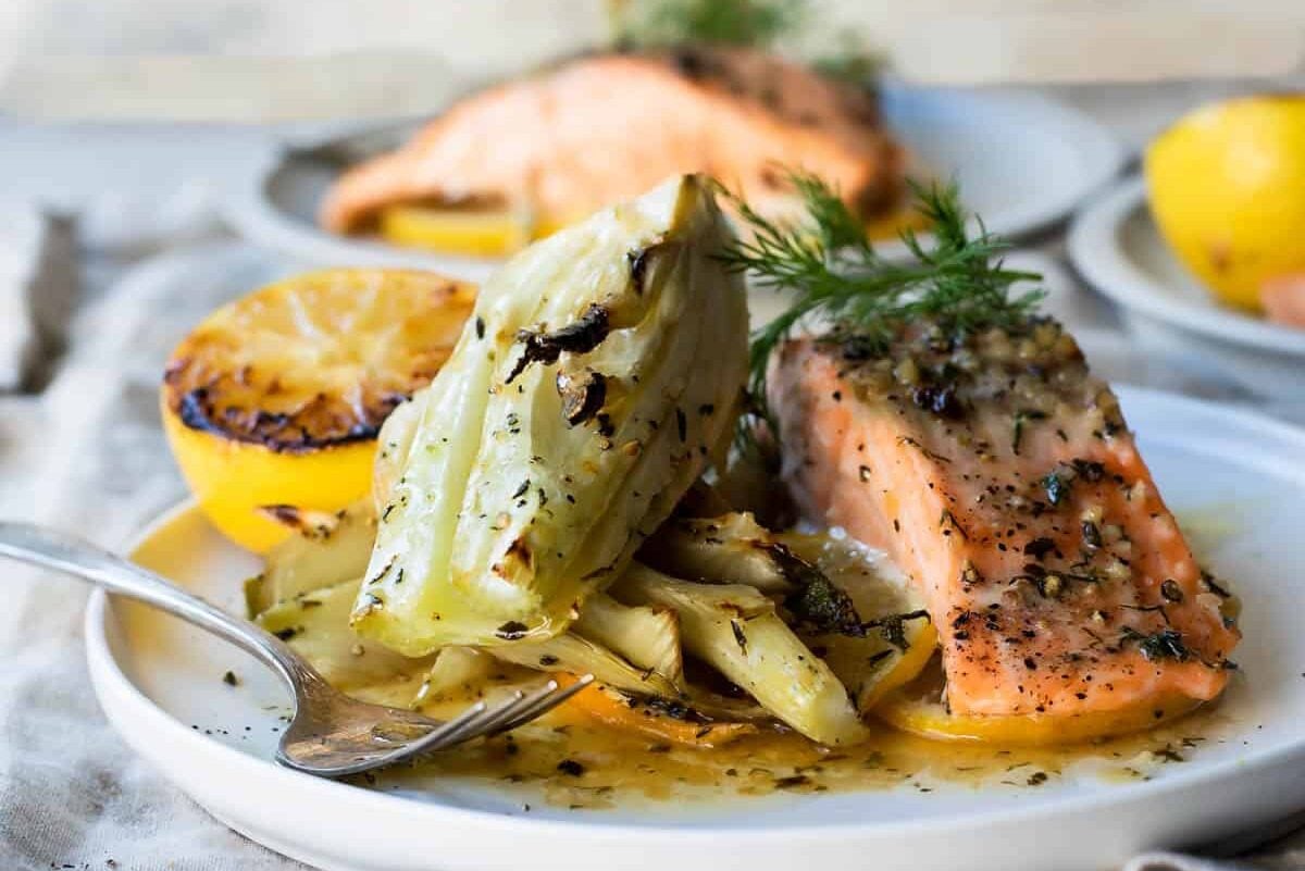 A salon filet and roasted fennel on a white plate.
