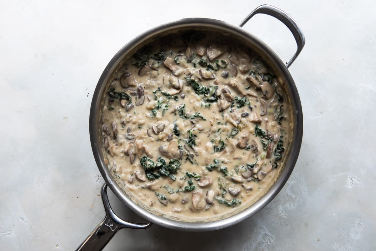 Vegetable pot pie mixture in a silver skillet.