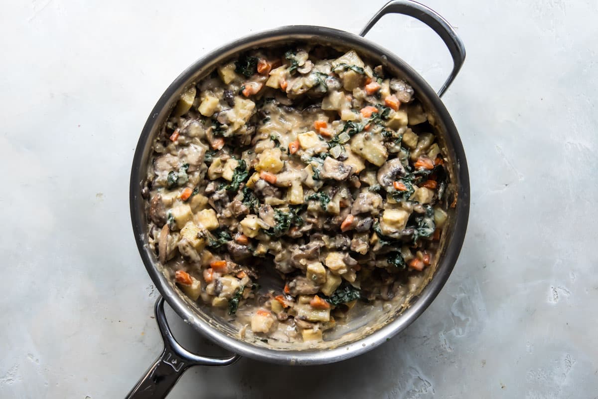 Vegetable pot pie mixture in a silver skillet.