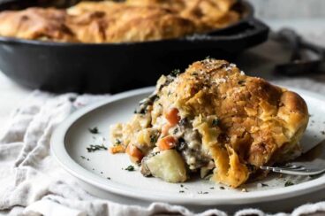 A piece of vegetable pot pie on a gray plate.