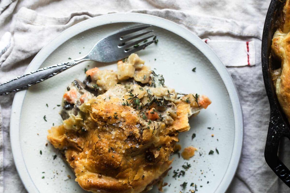 A piece of vegetable pot pie on a gray plate.
