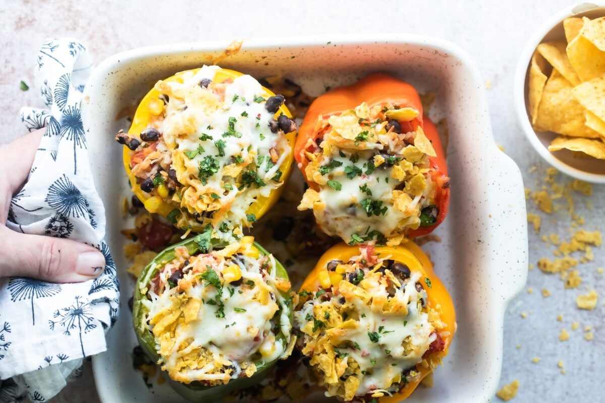 Vegetarian stuffed peppers in a white baking dish.