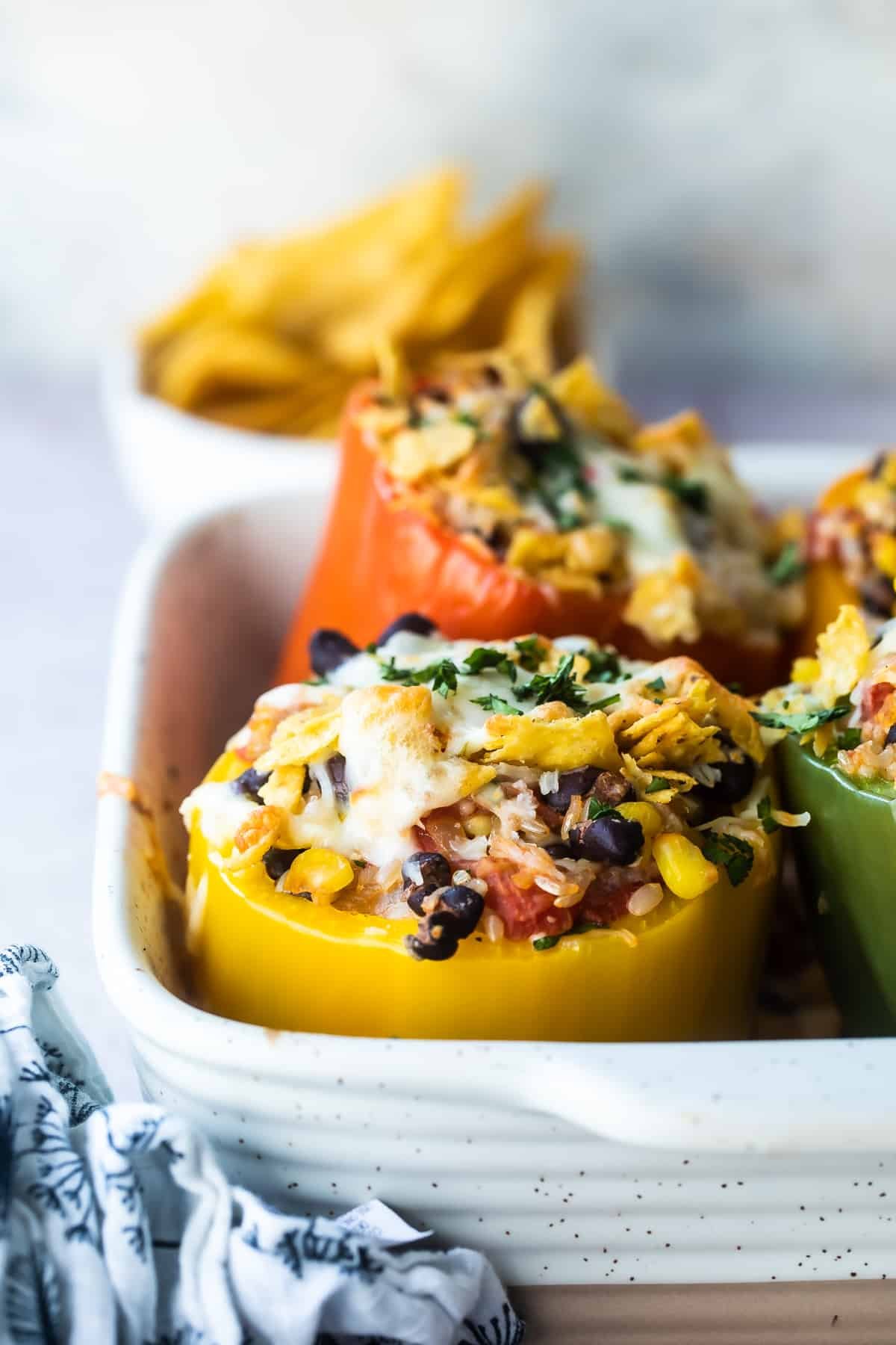 Vegetarian stuffed peppers in a white baking dish.