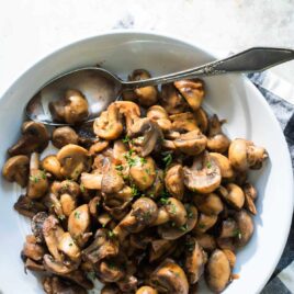 Balsamic mushrooms and onions in a white bowl.
