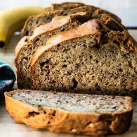 Banana bread slices on a piece of parchment paper.