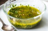 Chimichurri sauce in a small glass bowl.