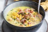 Corn chowder in a dark gray bowl.