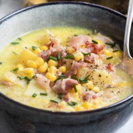 Corn chowder in a dark gray bowl.