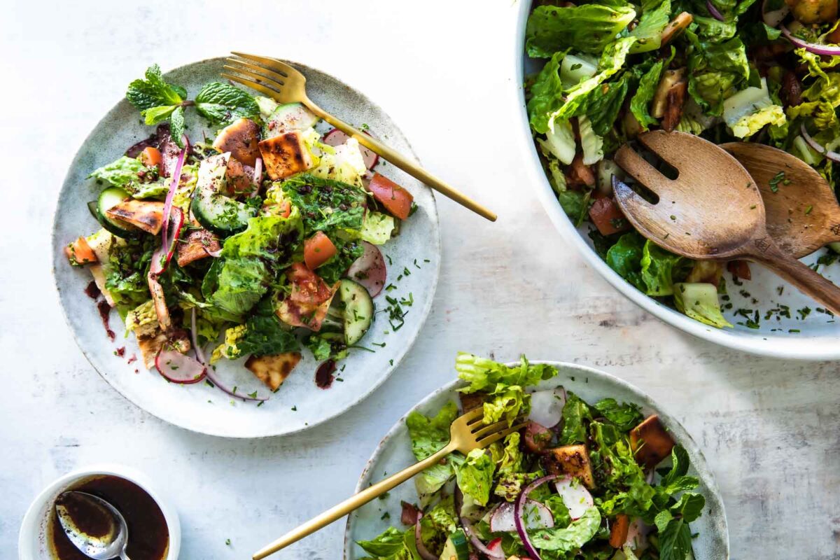 2 small bowls and 1 serving platter of fattoush salad.