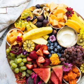 A platter of fresh fruit with fruit dip.