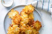 A plate with a stack of potato pancakes.