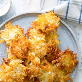 A plate with a stack of potato pancakes.