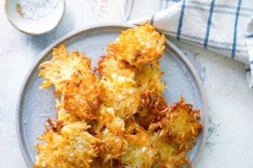 A plate with a stack of potato pancakes.