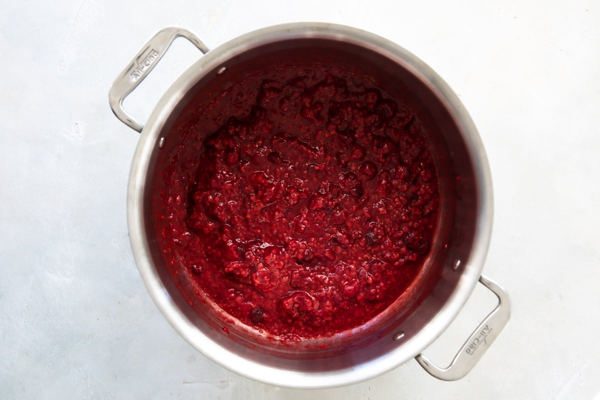Cooking frozen raspberries in a saucepan.
