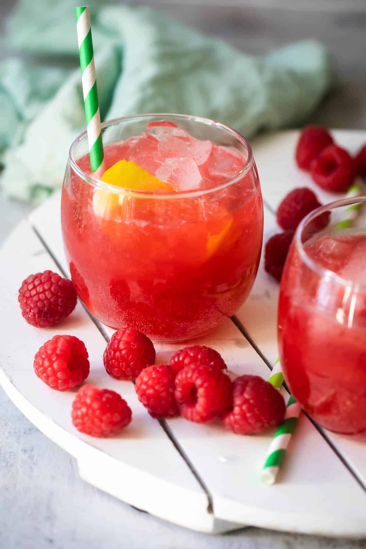 Glass of Raspberry Lemonade Fizz on a white board.