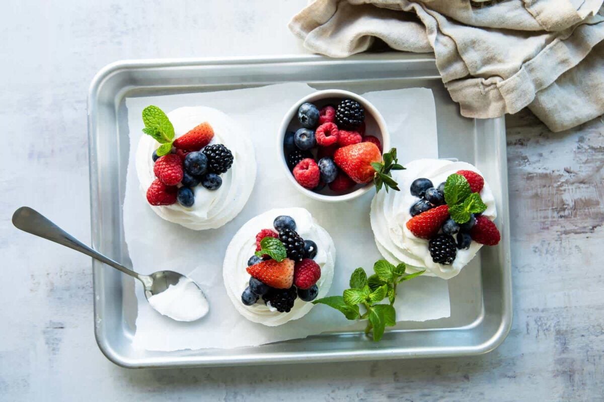 Three Schaum tortes on a silver baking sheet.
