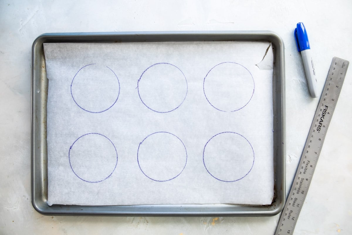 A piece of parchment paper with six circles drawn on it.