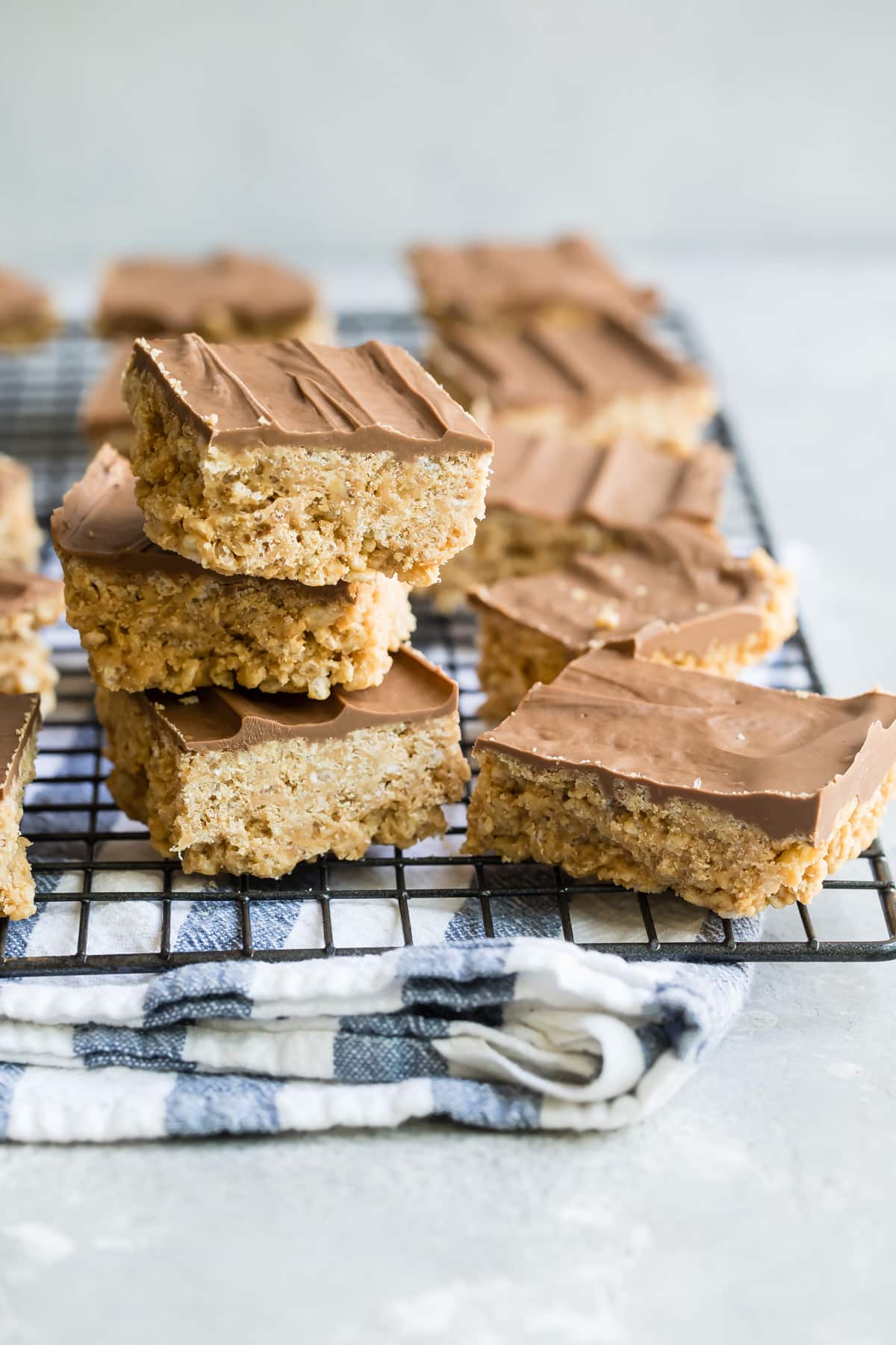 Scotcheroos piled on a baking rack.