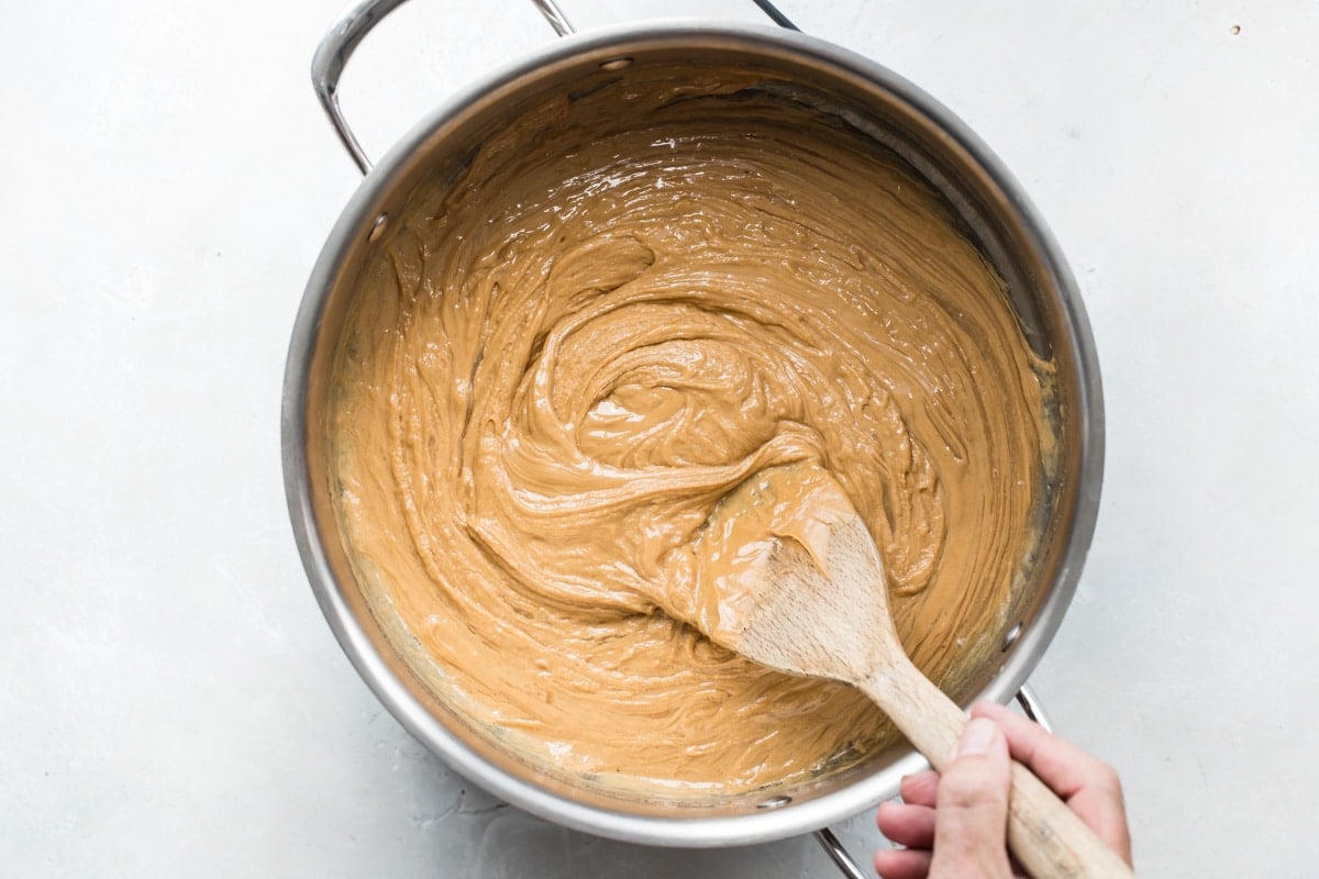 Stirring the peanut butter sauce for Scotcheroos.