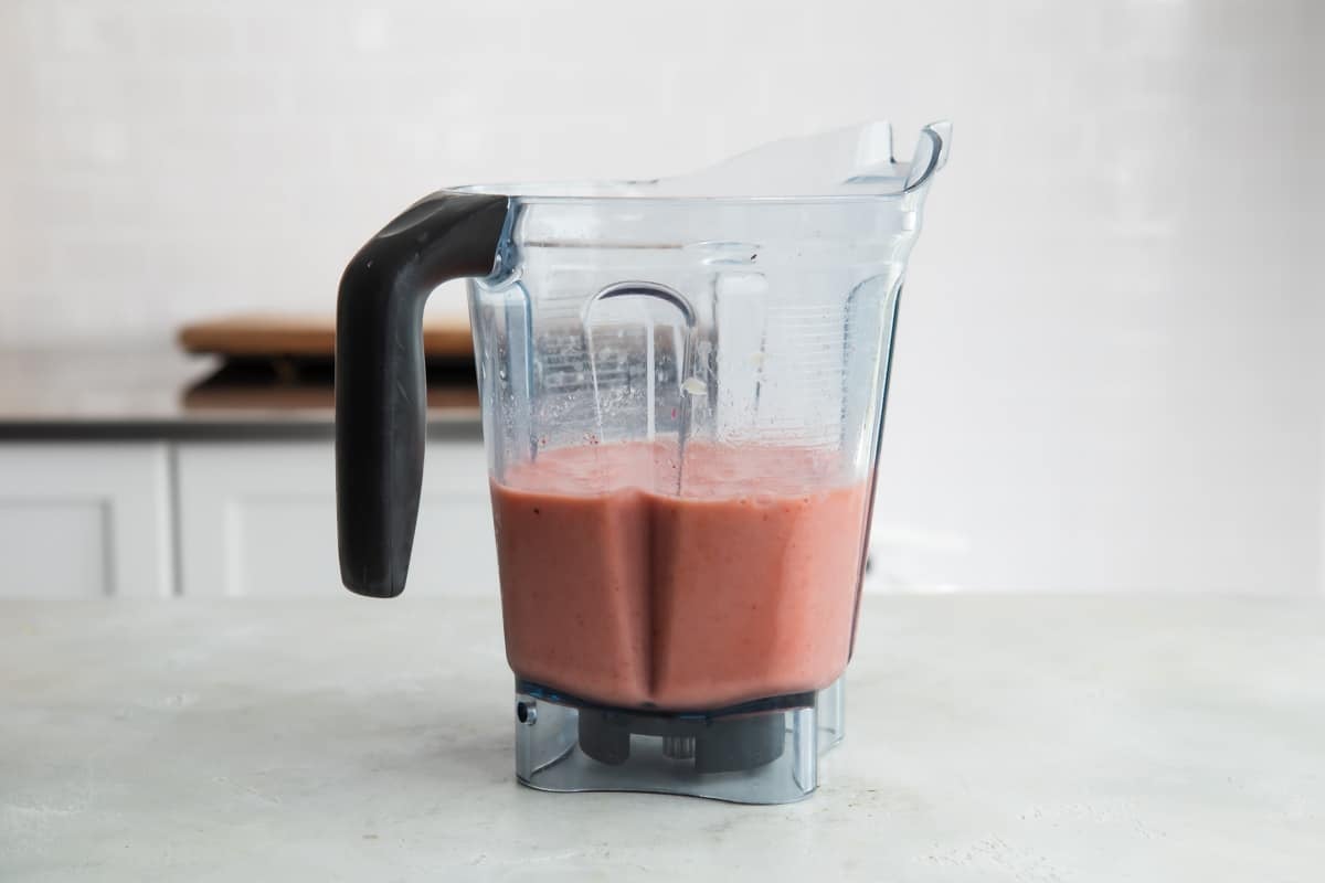 The ingredients for Strawberry Citrus Ginger smoothie in a blender, blended.
