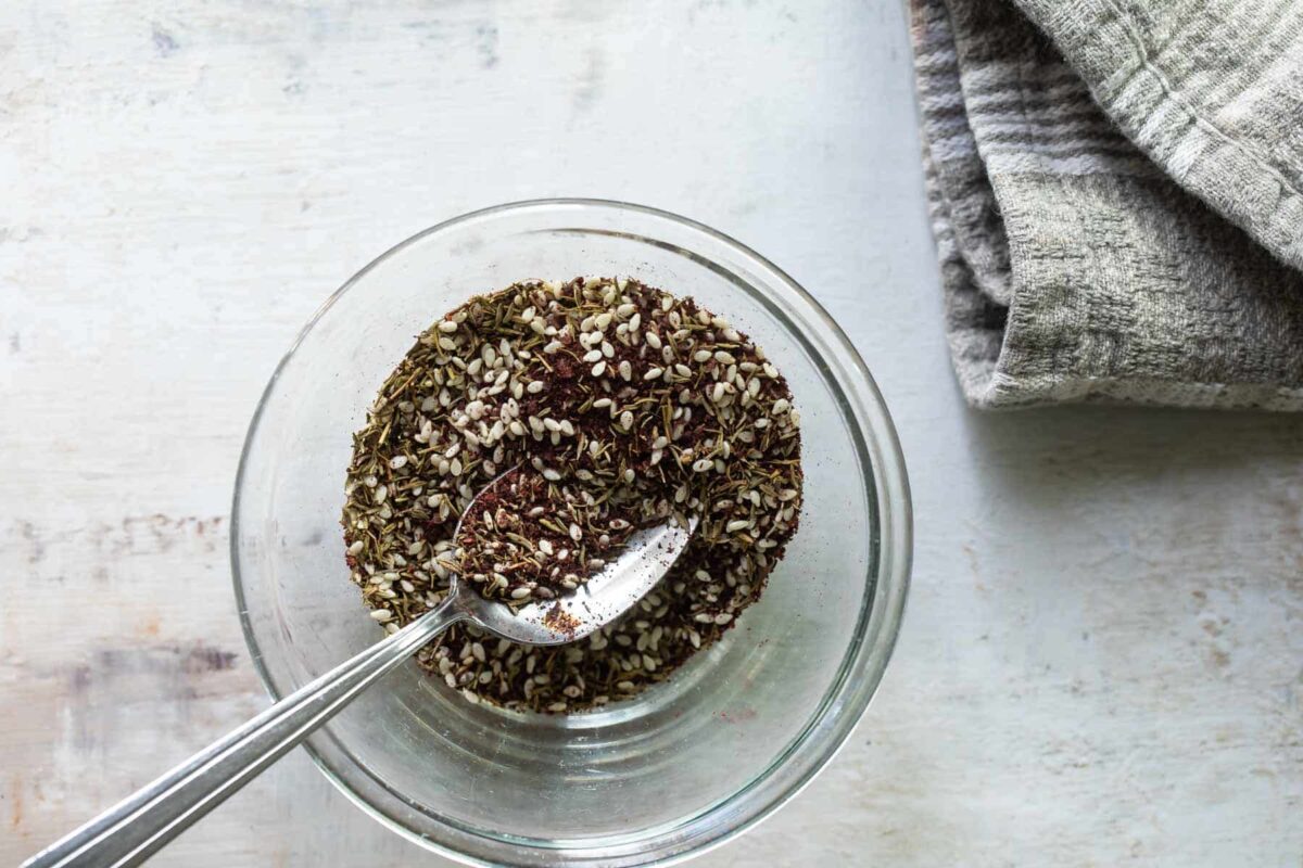 Za'atar seasoning in a clear glass bowl.