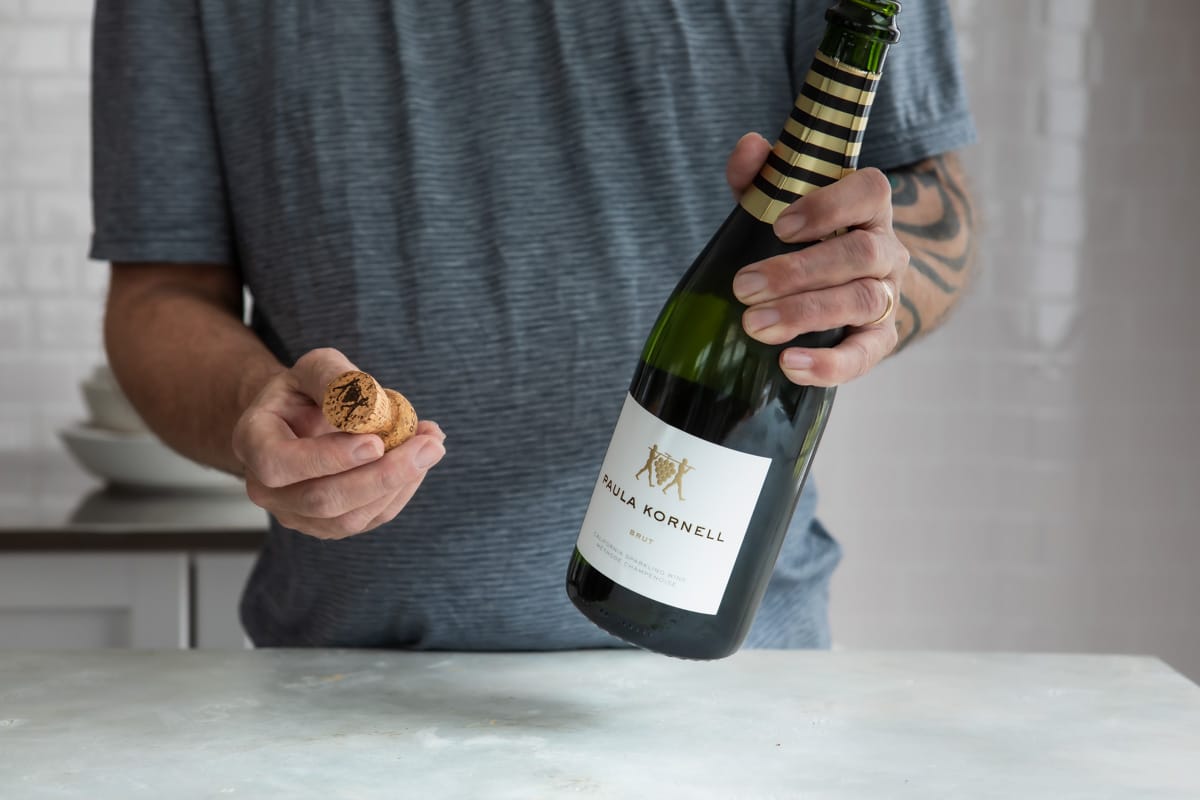 A bottle of champagne with the cork removed.