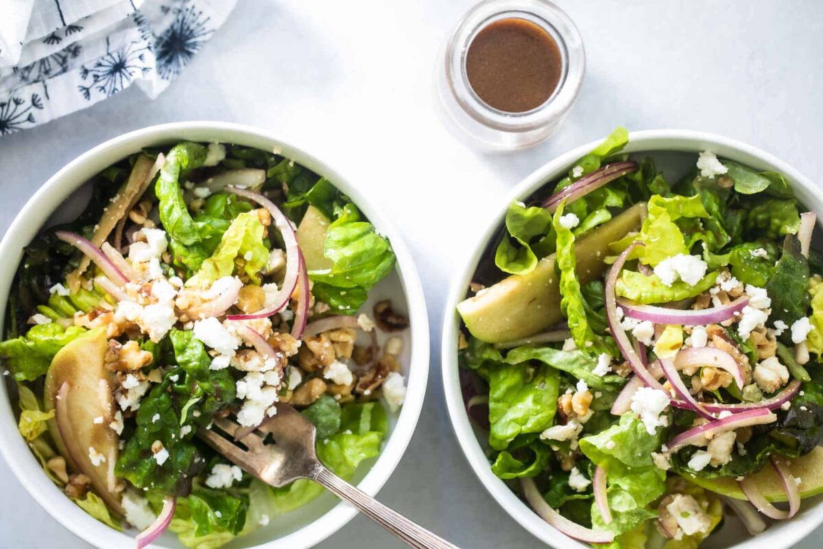 Two small bowls of apple walnut salad.