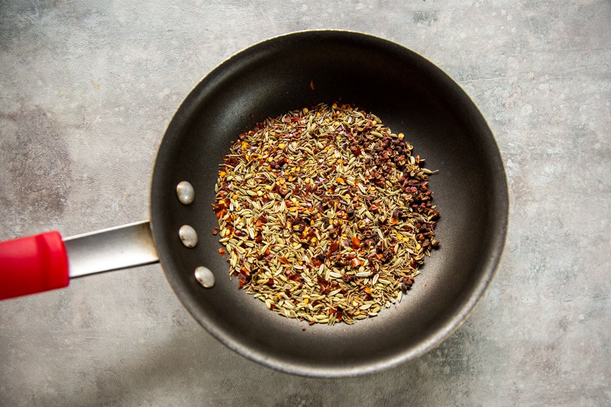 Toasting spices in a pan for Chinese Chicken Wings.