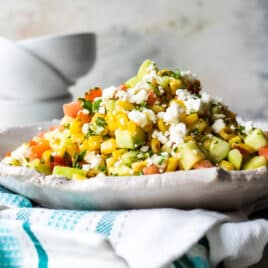 Corn salad on a white handmade platter.