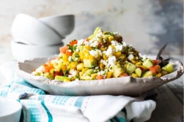 Corn salad on a white handmade platter.